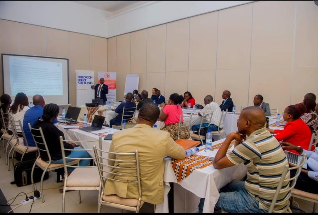 Delegates seated at round tables during the GFA and Friedrich-Ebert-Stiftung national dialogue on taxation.